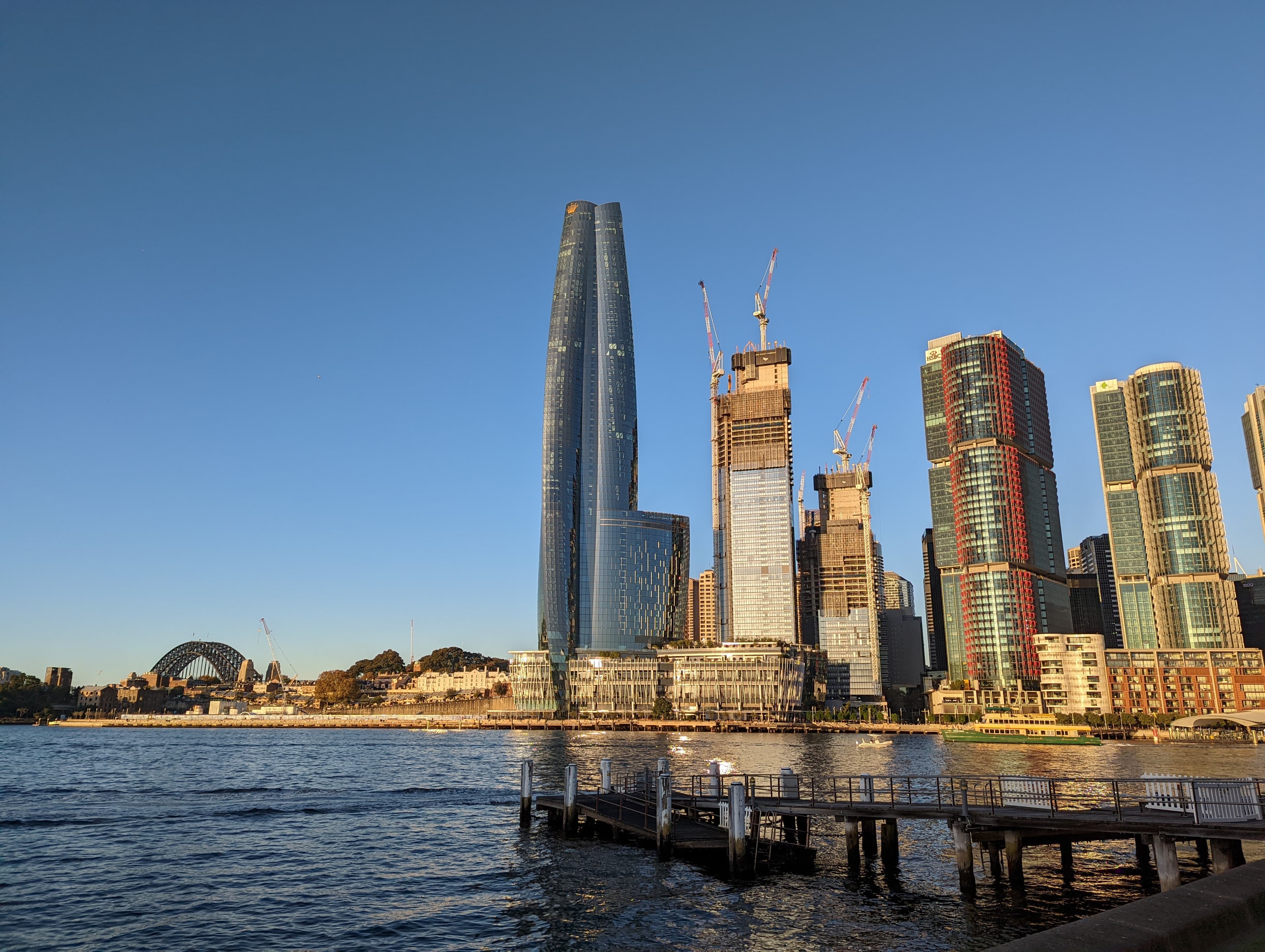 Towers under construction with cranes at Barangaroo, Sydney, the Harbour Bridge behind